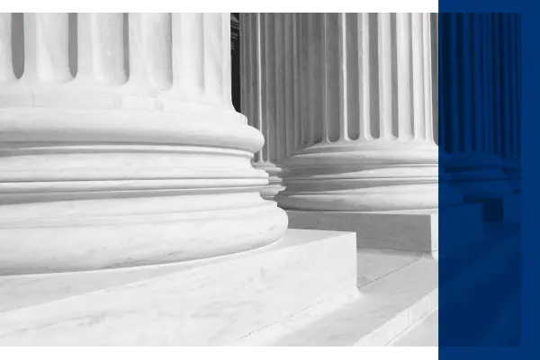 Black and white image of courthouse exterior steps with blue overlay