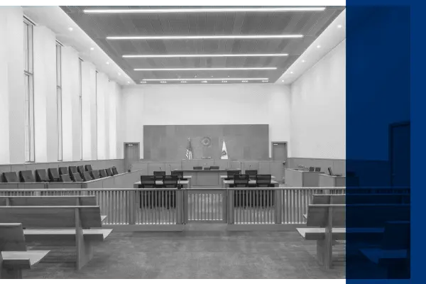 Black and white courtroom with dark blue overlay