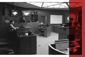 Black and white image of a proceeding taking place in a courtroom