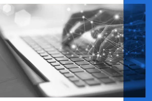 Black and white image of hands typing on keyboard with blue overlay and white dots