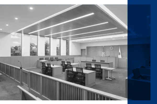 Black and white image of a courtroom featuring microphones