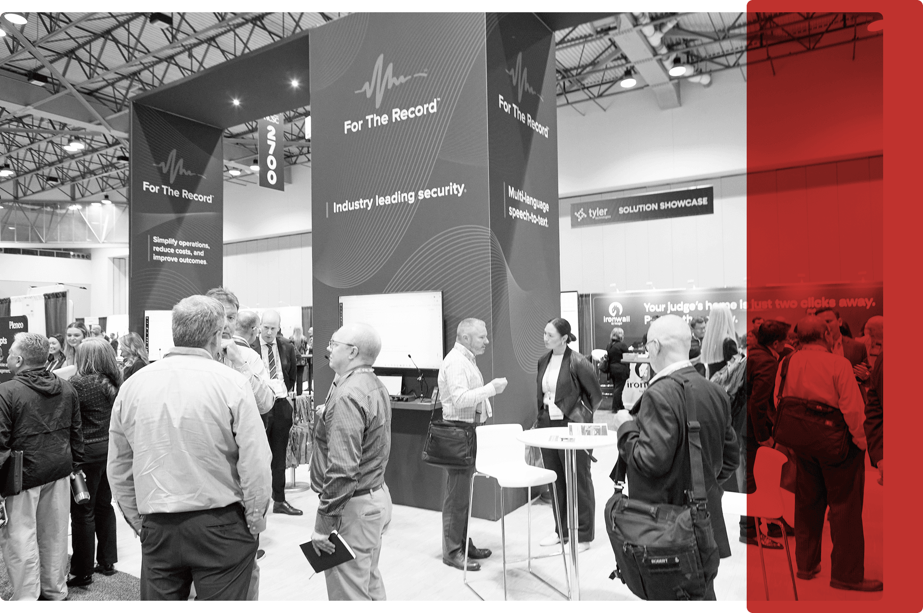 CTC 2025 Conference Booth_BW_Dark Red Overlay (1) People at a conference booth